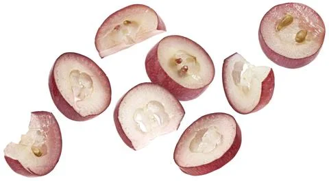 Falling red grape slices isolated on white background Stock Photos