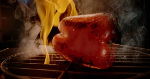 Falling red pepper on iron grate Stock Footage 311832615