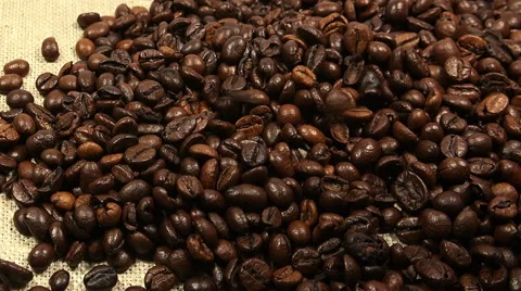 Falling Roasted Coffee Beans on a Canvas Background. Full HD Stock Footage 47916702