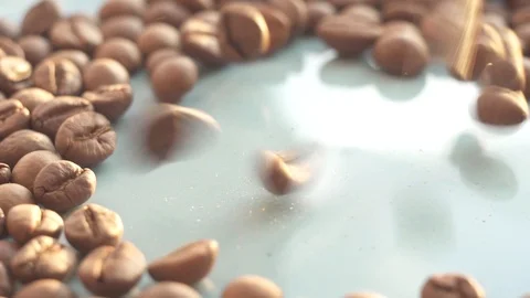 Falling roasted coffee beans close-up, sunlight Stock Footage 89812066