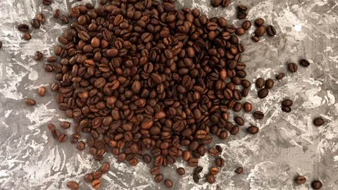 Falling roasted coffee beans on grey background Stock Footage 112865217