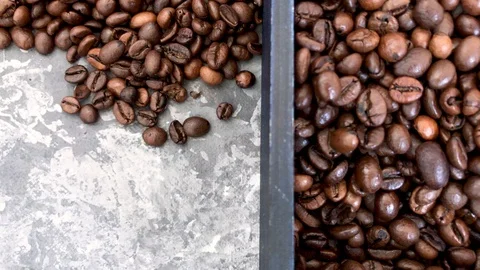 Falling roasted coffee beans on grey background Stock Footage 112927140