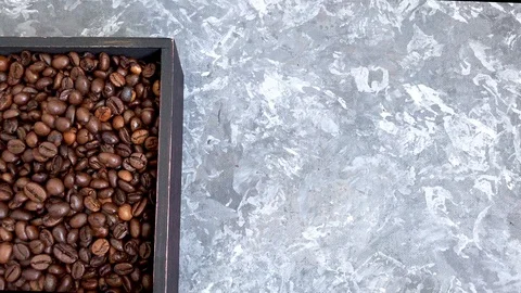 Falling roasted coffee beans on grey background Stock Footage 113197869