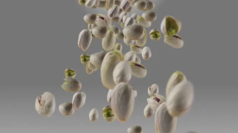 Falling of Roasted Pistachios in Grey Background Stock Footage 148388080