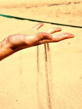 Falling sand from hand Stock Photos