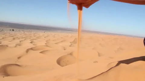 Falling sand out of hand Stock Footage 21251700
