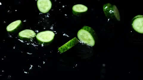 Falling of segments of a cucumber. Slow motion. Stock-Footage 97846665