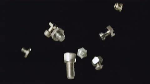 Falling silver nuts and bolts shiny stainless steel slow motion Stock Footage 159517610