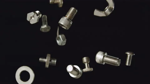 Falling silver nuts and bolts shiny stainless steel slow motion Stock Footage 159518684