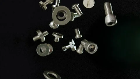 Falling silver nuts and bolts shiny stainless steel slow motion Stock Footage 159518801