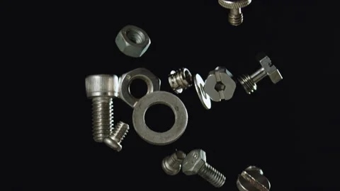 Falling silver nuts and bolts shiny stainless steel slow motion Stock Footage 159519475