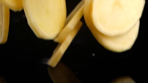 Falling of sliced potatoes into the table. Stock Footage 121783241