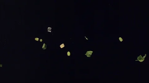 Falling slow mo ice veggies and fruit over black B Stock Footage 109574304