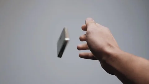 Falling smartphone at floor slow motion. Close up of man's hand drop phone Stock-Footage 70725893