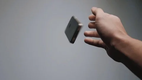 Falling smartphone at floor slow motion. Close up of man's hand drop phone Stock-Footage 70726349