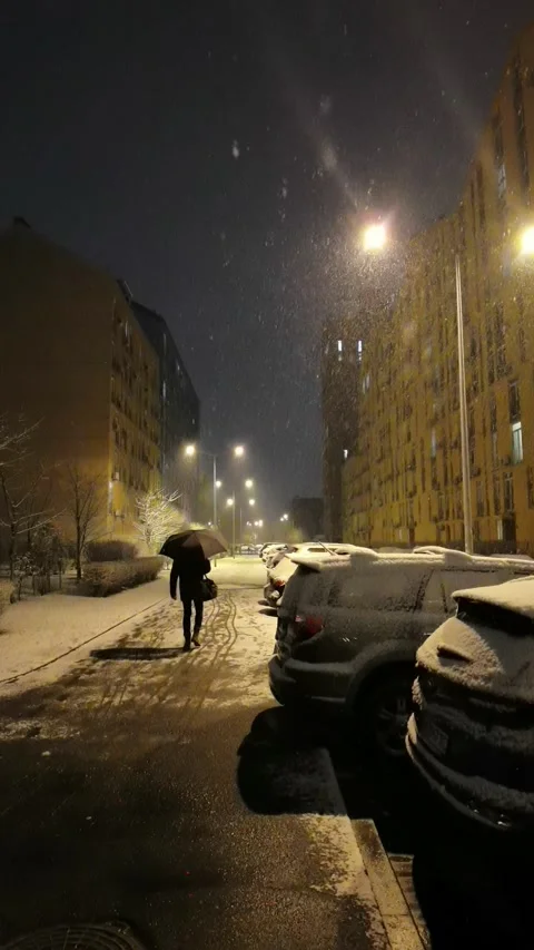 Falling snow backlit with modern street lamp in city street at night in winter. Stock Footage 183044632