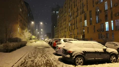 Falling snow backlit with modern street lamp in city street at night in winter. Stock Footage 183045129