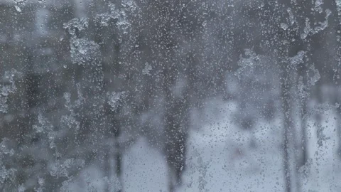 Falling snow behind glass during snowfall Stock Footage 253432767
