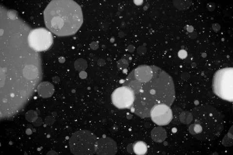 Falling snow on black background. Stock Photos