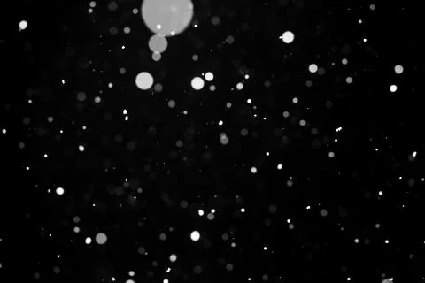 Falling snow on black background. Stock Photos