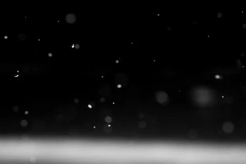 Falling snow on black background. Stock Photos