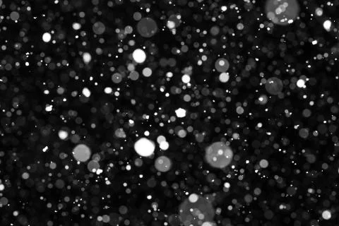 Falling snow on black background. Stock Photos