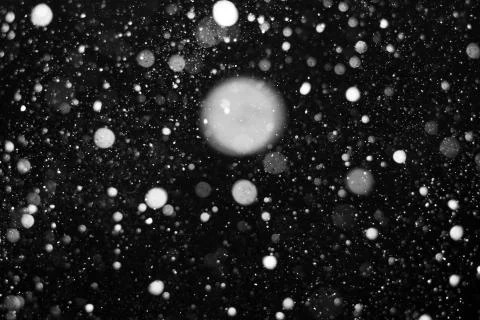 Falling snow on black background. Stock Photos