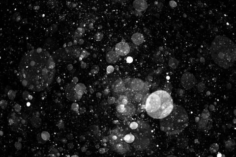 Falling snow on black background. Stock Photos