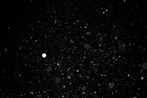 Falling snow on black background. Stock Photos