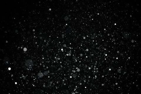 Falling snow on black background. Stock Photos