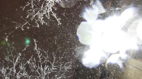 Falling snow on a black background. Urban shower snow. Sparkle on lens. Vídeo Stock 143048738