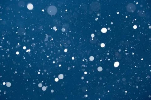 Falling snow on blue background. Stock Photos