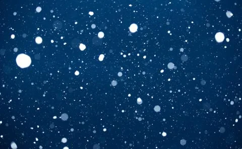 Falling snow on blue background. Stock Photos