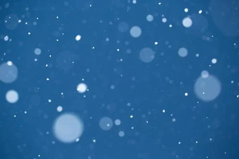 Falling snow on blue background. Stock Photos