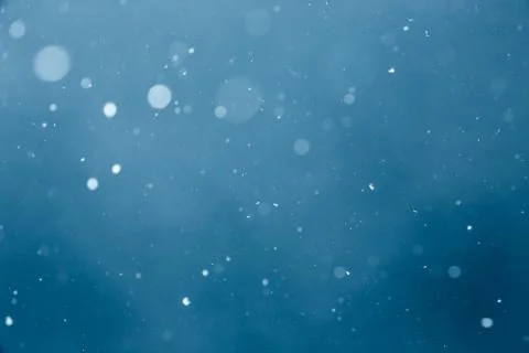 Falling Snow On The Blue Background Stock Photos