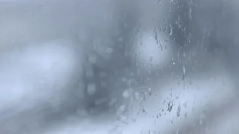 Falling snow on blurred window background, blurred background in winter Stock Footage 169482236