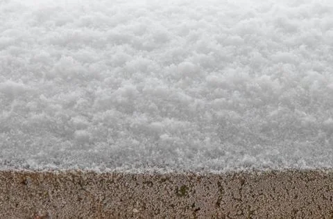 Falling snow on concrete. Stock Photos