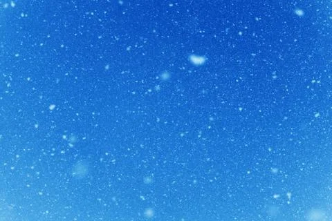 Falling snow flakes during the snowfall from the sky. Stock Photos