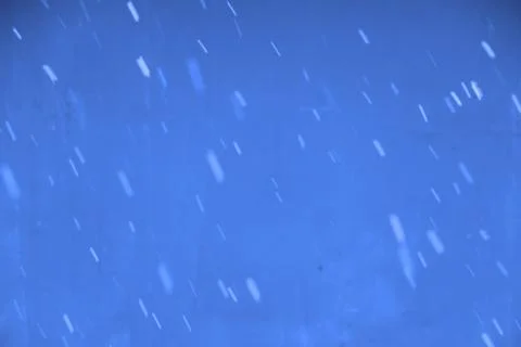 Falling snow flakes during the snowfall from the sky. Stock Photos