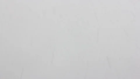 Falling snow on grey background Stock Footage 96995843