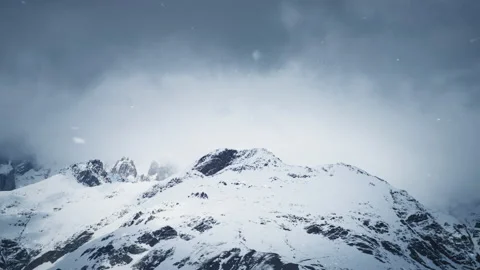 Falling snow in mountain peaks Stock Footage 167684737