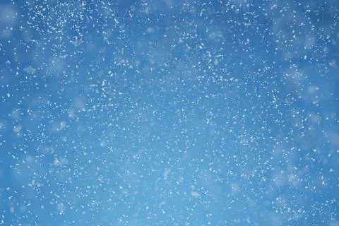 Falling snow over blue background with copy space Stock Photos