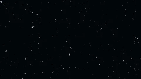 Falling snow particles against deep black background slow motion Stock Footage 327511127
