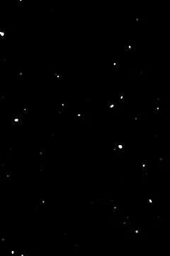 Falling snow particles on black background, winter overlay layer for video Stock Photos