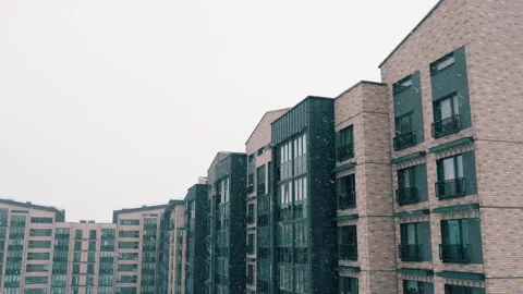Falling snow, snowfall in the yard of modern block of flats, snowflakes in Stock Footage 149524089