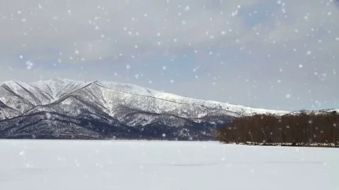 Falling snow in a winter landscape background - looping snow Stock Footage 69157436