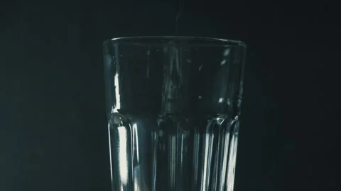 Falling sparkling water in an empty glass Stock Footage 130858406