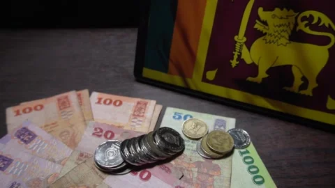 Falling Sri Lankan Coins with Notes and Flag on Dark Table Stock Footage 300095422