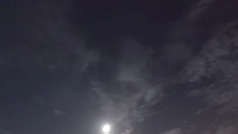 Falling star n moon light ray flare shining through white clouds n night sky Stock Footage 161958570