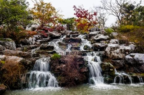 Falling stream in autumn Stock Photos
